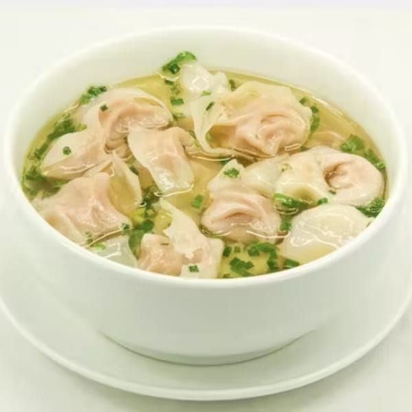 A white bowl of wonton soup with green onions, served at Rice Bowl Cafe.
